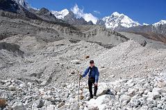 Rolwaling 06 07 Jerome Ryan On Trakarding Glacier With Chugimago Behind Jerome Ryan on the Trakarding Glacier with Chugimago behind, showing the rough trail on thousands of sharp rocks, stones, sand-heaps and ice-walls.